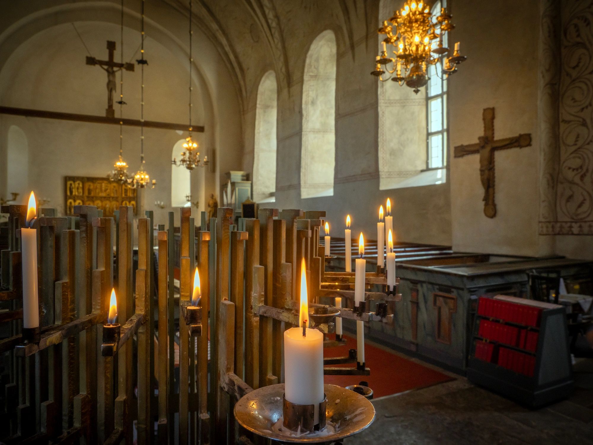 Lit prayer candles inside a church